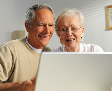 Photo of a couple looking at a computer. Links to Tangible Personal Property